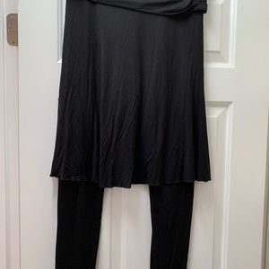 Black stretchy pants with skirt overlay.